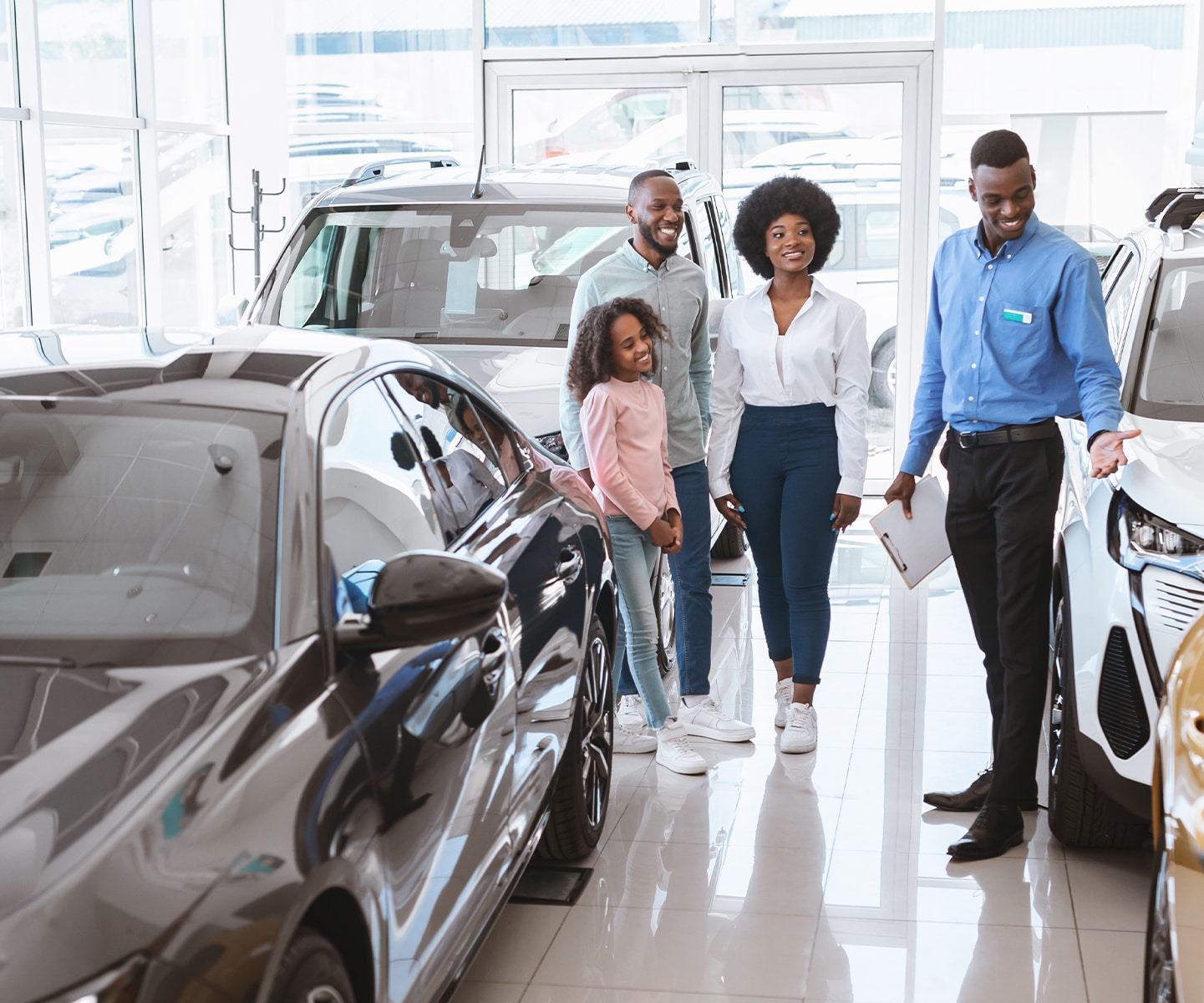 Chrysler Dodge Jeep Ram Dealer Near Clearfield | Sales person showing a family the car options available in the dealership