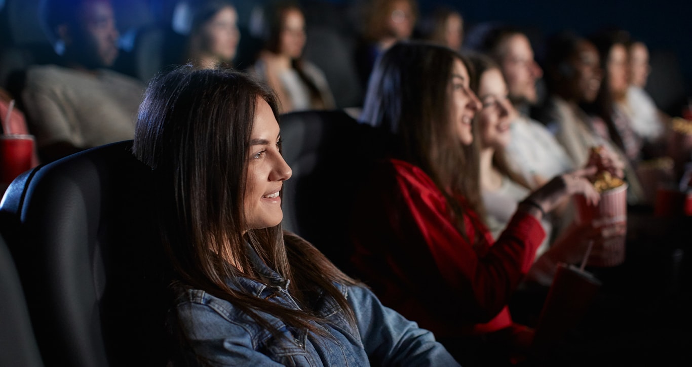 Chrysler Dodge Jeep Ram Dealer Near St Marys | People sitting in movie theater seats watching a movie