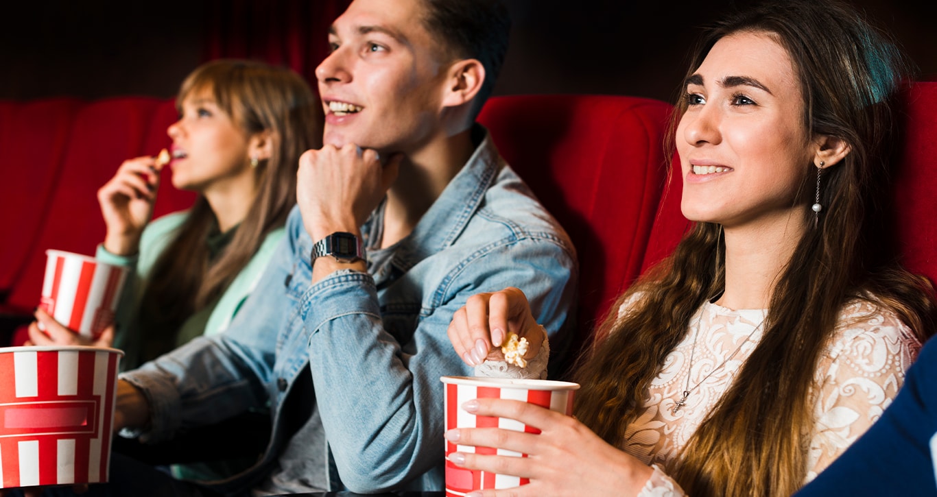 Chevy Dealer in Mt Pleasant | Friends at the movie theater eating popcorn