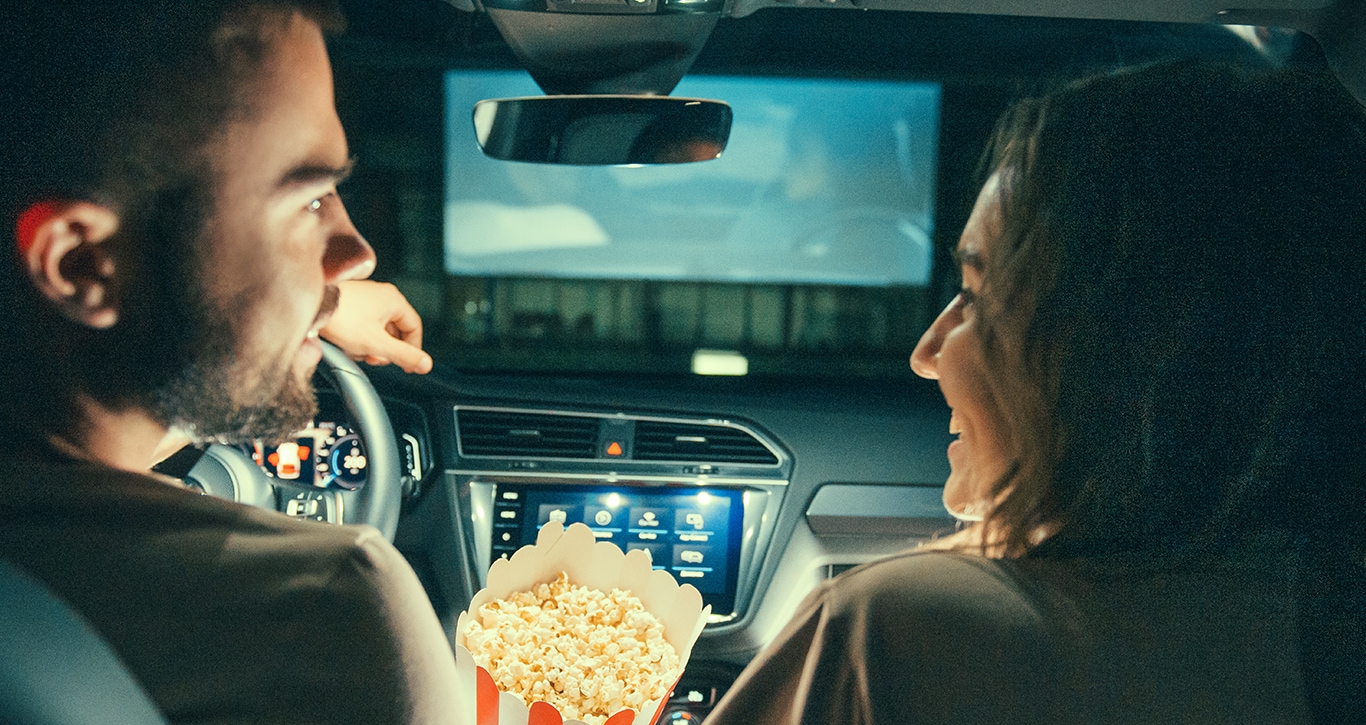 Hyundai Dealer Near Brookville | Couple watching a movie while sitting in their car laughing