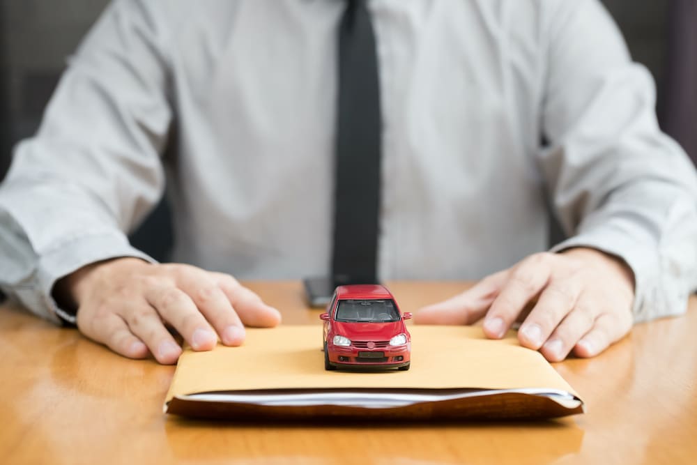Folder with Documents and Toy Car on Top