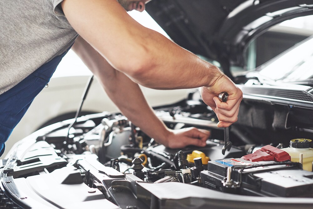Technician Working on Engine of Car