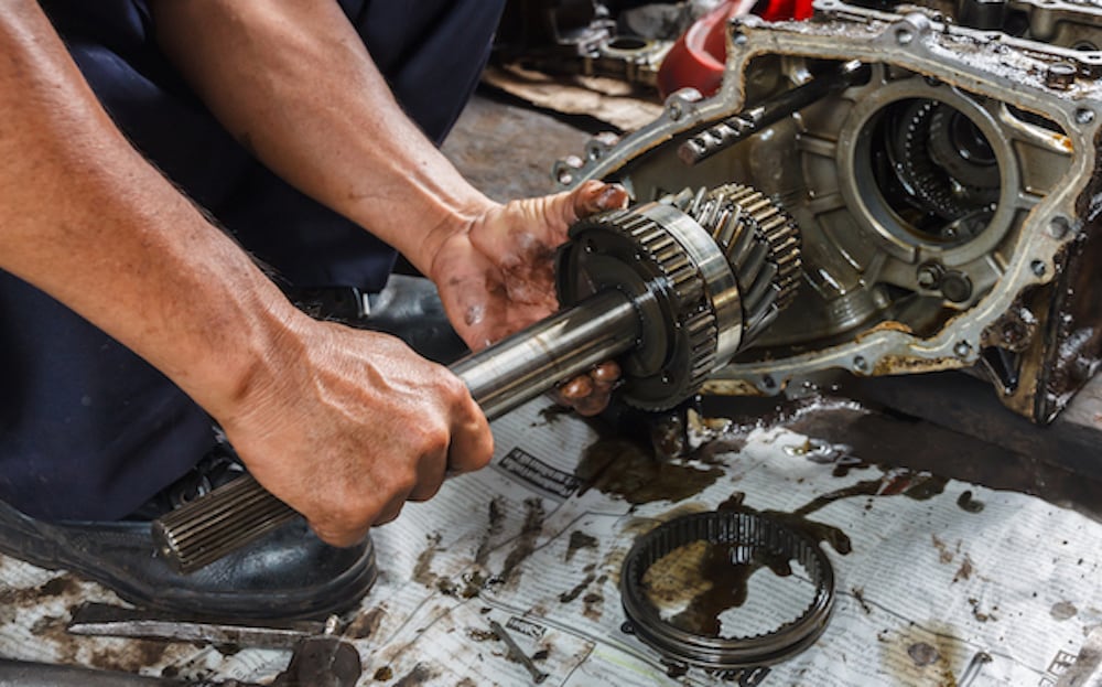 Technician Replacing Transmission