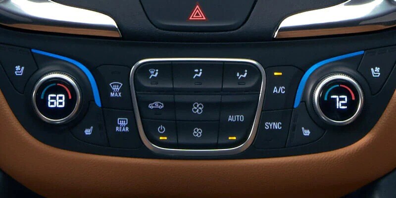 A Chevrolet's climate control system up close with chocolate brown accents