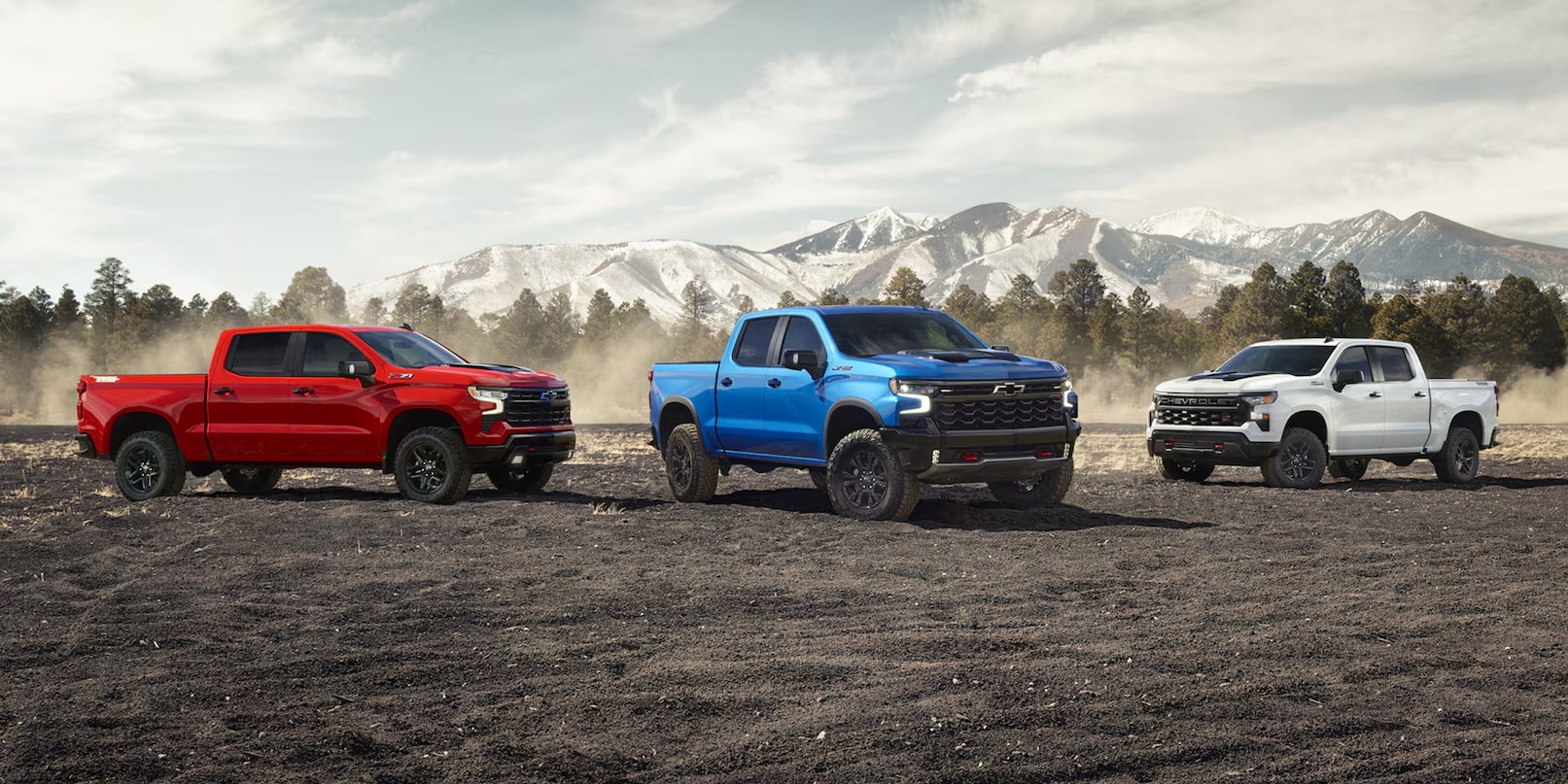 Chevrolet Silverado trucks on a mountain overlook