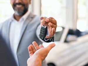 Salesperson delivering keys to customer