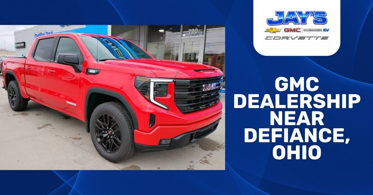 Promotional graphic showing a red GMC pickup truck parked in front of a dealership, Jay's Chevrolet GMC, building beside bold text reading GMC Dealership Near Defiance, Ohio and the Jay’s Chevrolet GMC Hummer EV Corvette logo.
