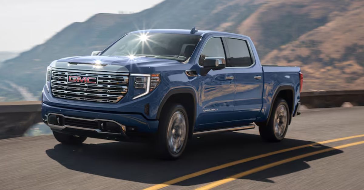 Blue GMC Sierra 1500 driving on a mountainous overpass