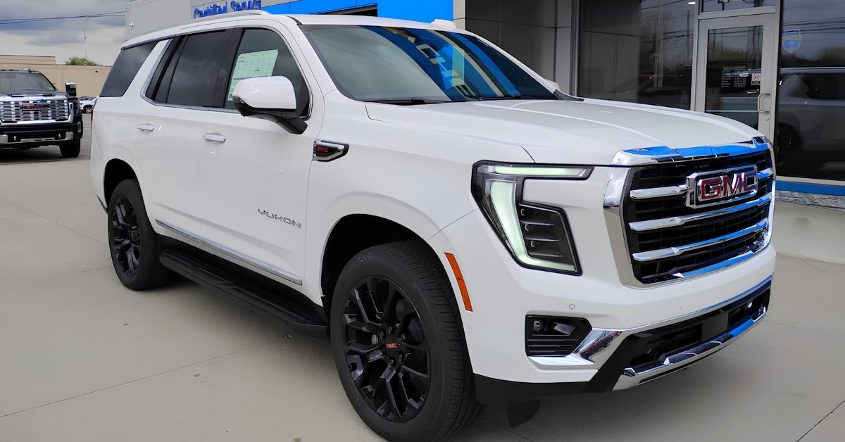 White 2026 GMC Yukon Elevation SUV with black wheels parked outside Don's Chevrolet GMC, a GMC dealership near Toledo, OH, shown from a front three-quarter angle.