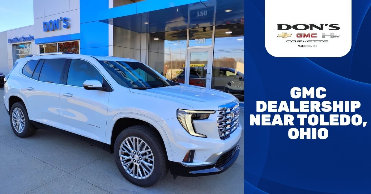 White 2026 GMC Acadia Denali SUV parked outside Don’s Chevrolet GMC in Wauseon, Ohio, with promotional text reading “GMC Dealership Near Toledo, Ohio.”