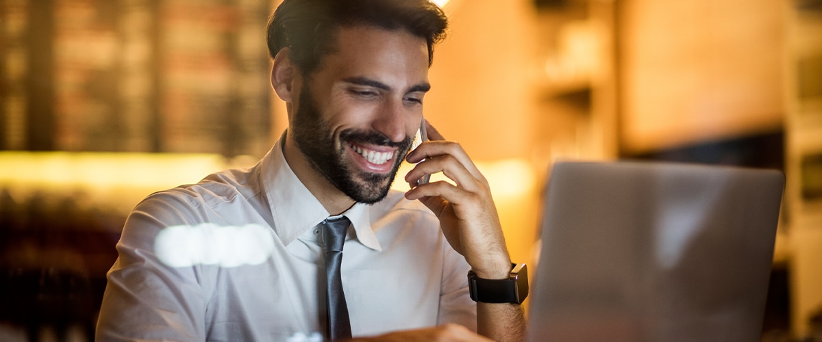 Man Smiling at Laptop