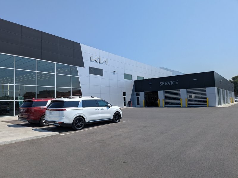 The service entrance at Doug Smith Kia with vehicles parked outside