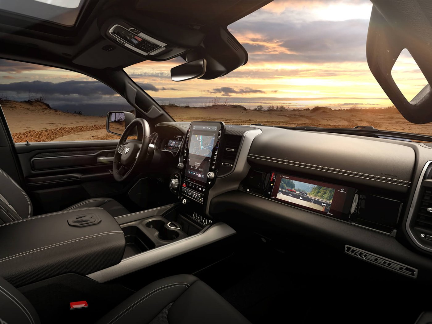 The dashboard, center touchscreen and passenger screen of a 2027 Ram 1500 Rebel