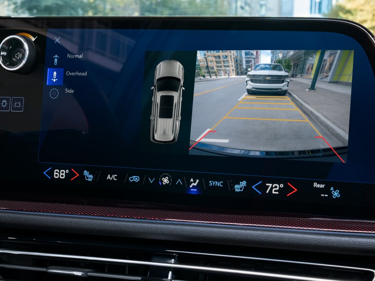 The Traverse touchscreen showing HD Surround Vision, with an overhead view of the vehicle beside the rear camera view