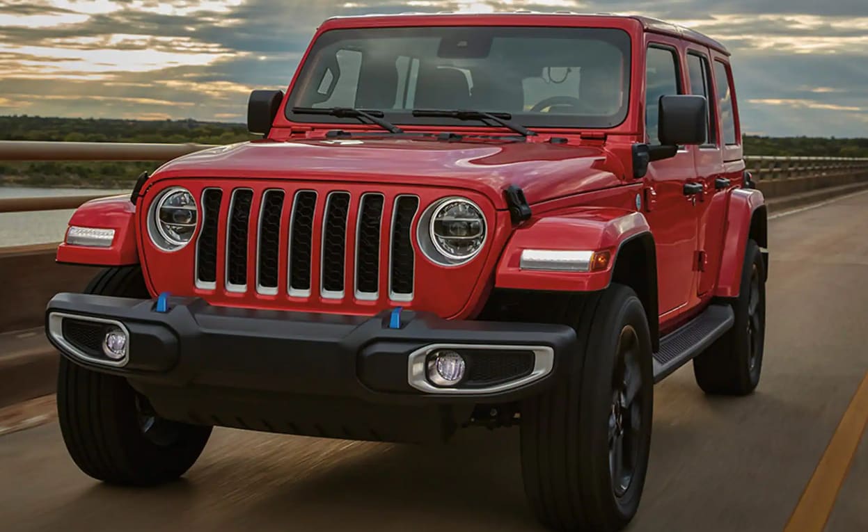 2023 Jeep Wrangler in red color driving on the road