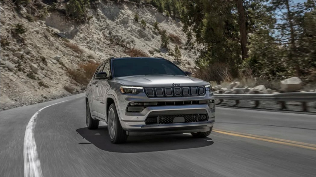2023 Jeep Compass driving on an opening road