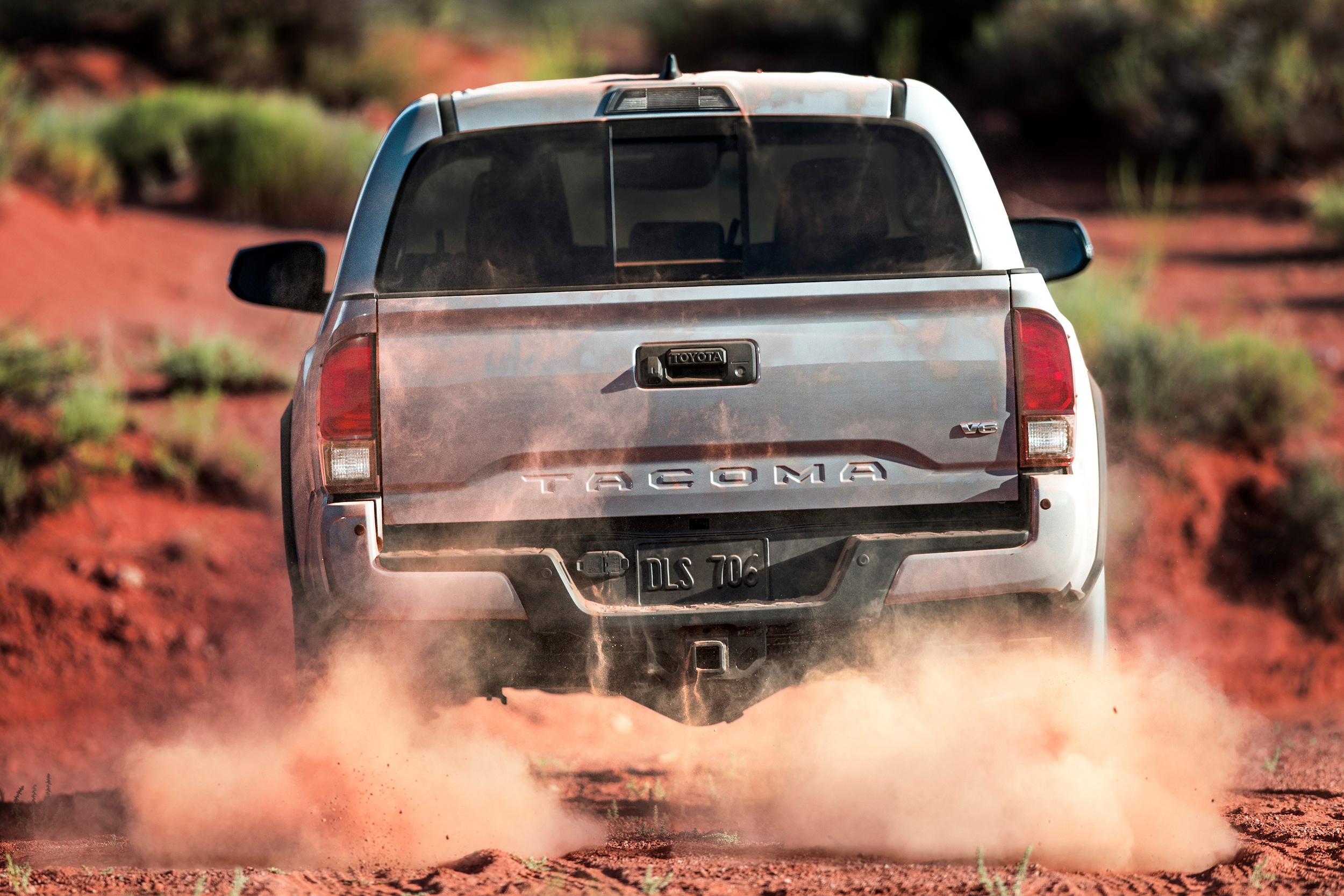 Rear shot of the 2018 Toyota Tacoma off-roading through the dirst