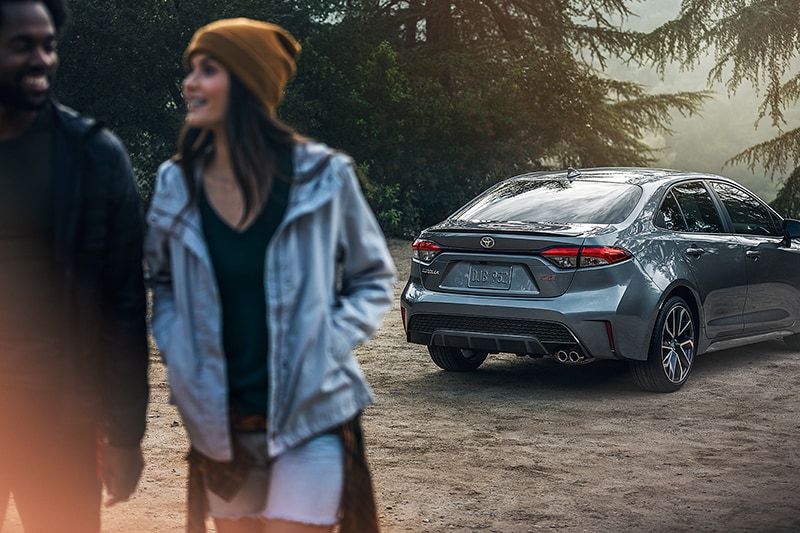 Johnstons Toyota is a Car Dealership in New Hampton near Scotchtown NY | Two people walking away from 2020 Toyota corolla