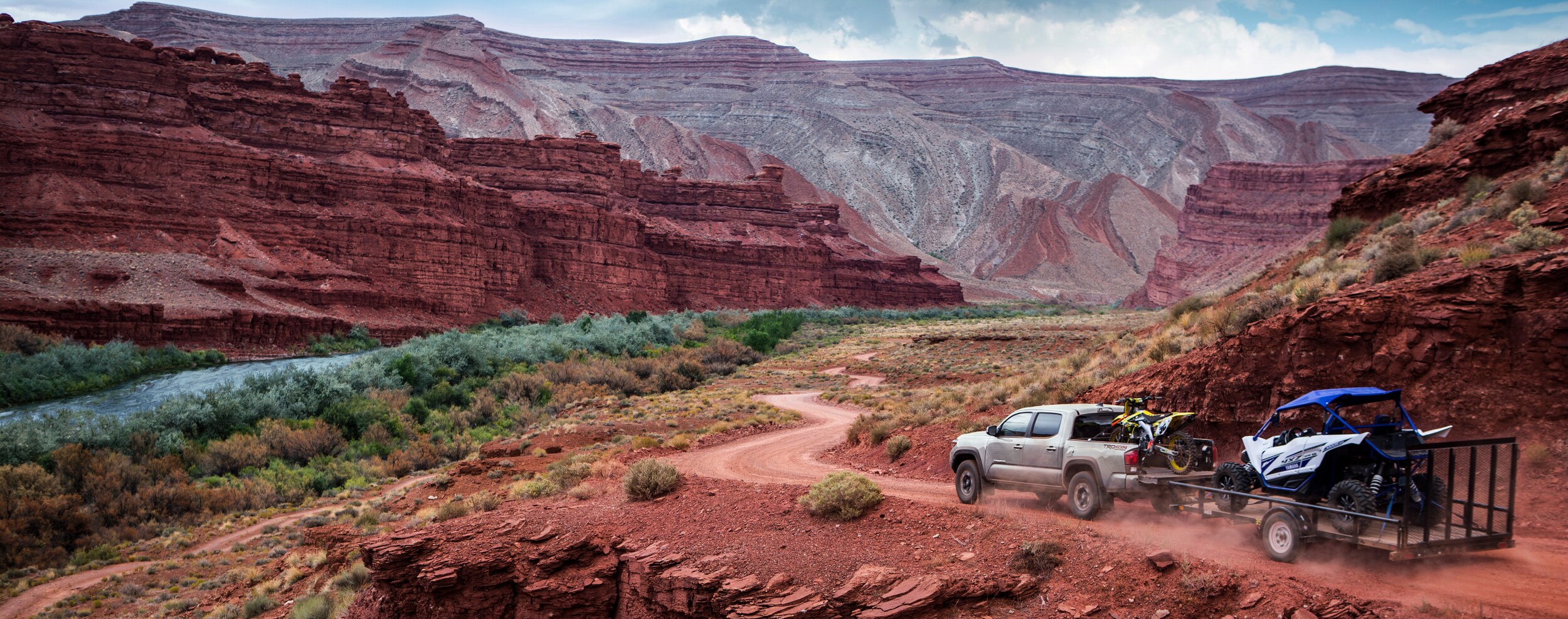 2018 Toyota Tacoma towing a small trailer off-road