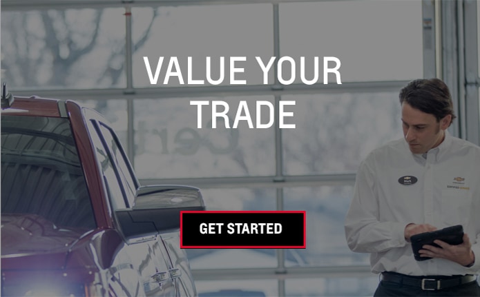 photo of a dealership employee appraising a vehicle and text that says Value Your Trade - Get Started