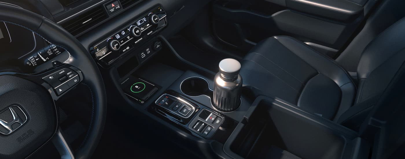 A close up of the black interior and center console of a 2023 Honda Pilot for sale near Ruston, LA is shown.