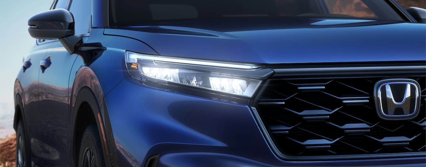 A close up of the blue grille on a 2023 Honda CR-V for sale is shown.