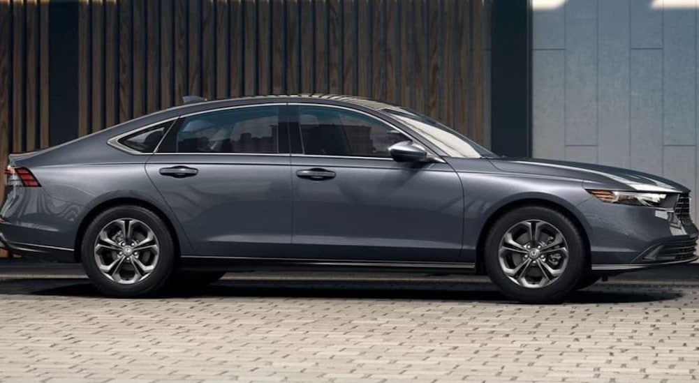 A gray 2024 Honda Accord is shown parked near a building.