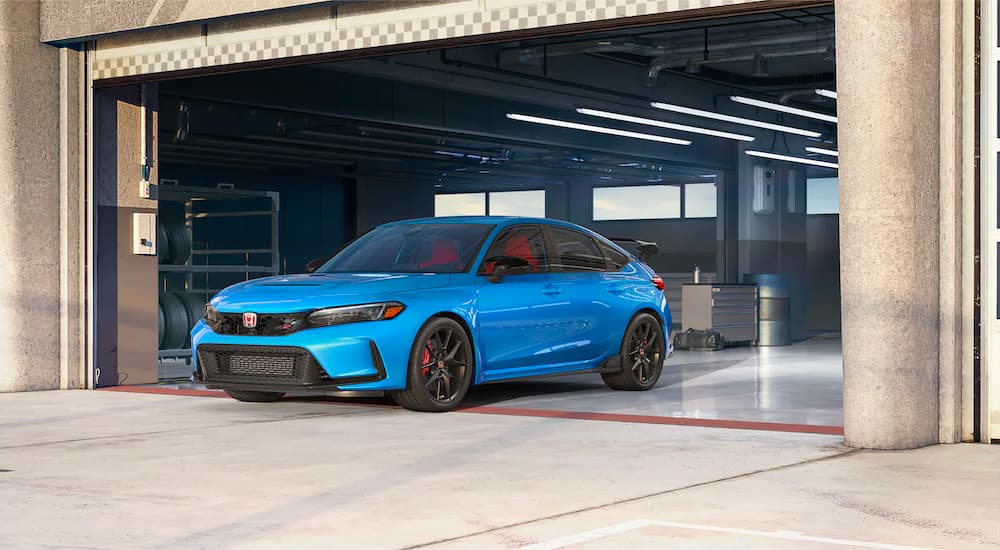 A blue 2023 Honda Civic Type R is shown leaving a garage after leaving a Honda dealer near you.