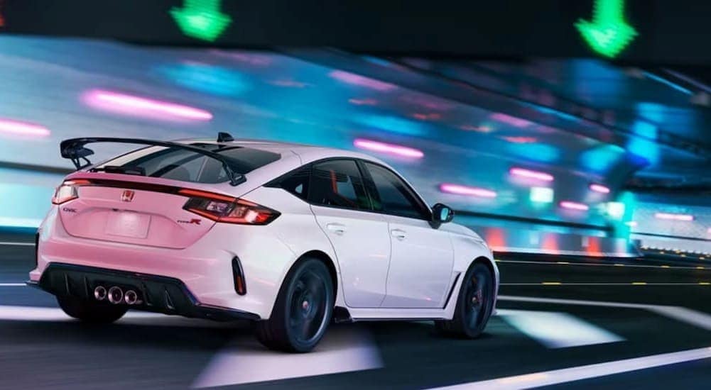 A white 2024 Honda Civic Type-R is shown driving in a tunnel.