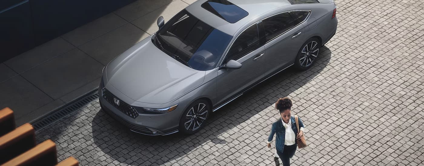 A grey 2023 Honda Accord Touring is shown from a high angle parked on a city street.