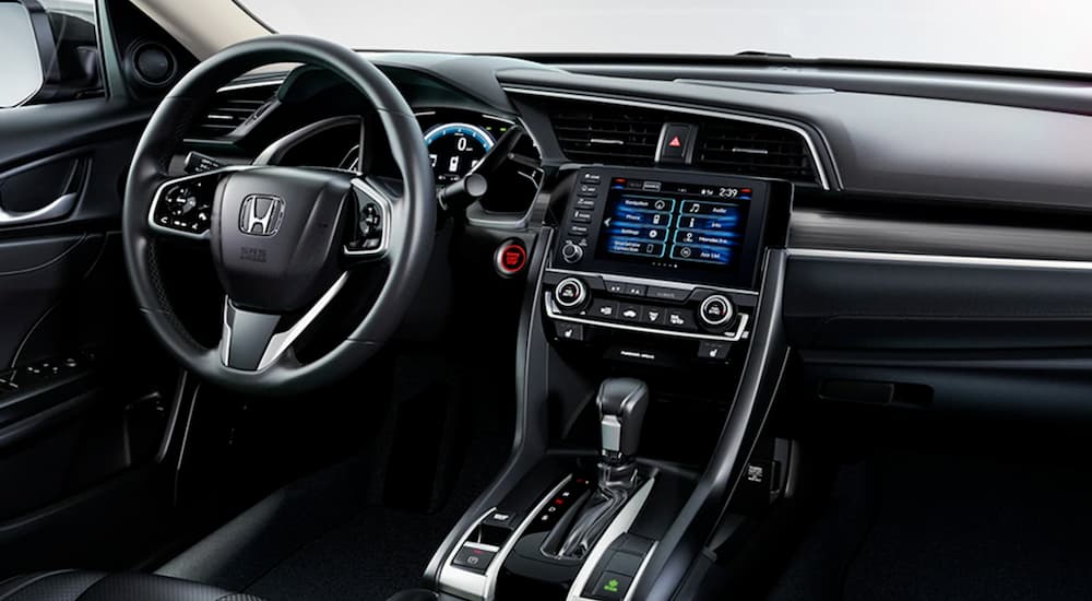 The steering wheel and center console in a 2020 used Honda Civic for sale.