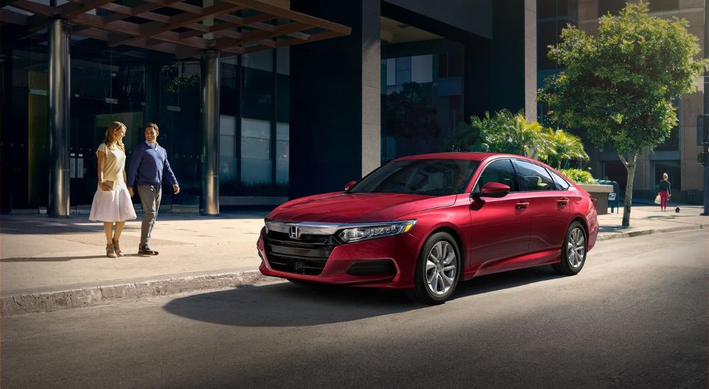 A red 2020 Honda Accord parked by a curb.