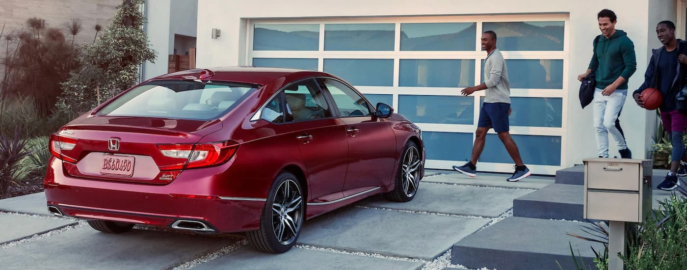 Rear view of a red 2021 Honda Accord parked in a driveway.