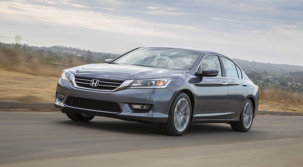 Left angled view of a grey 2015 used Honda Accord for sale driving.