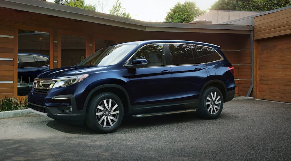 A blue 2021 Honda Pilot EX-L is shown parked on a driveway.