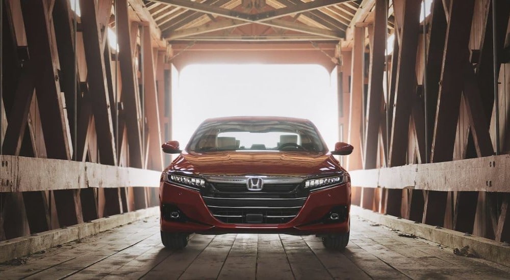 2021%20Honda%20Accord%20-%20Bridge%202.jpg A popular used Honda Accord for sale, a red 2021 Honda Accord, is shown parked on a covered bridge.
