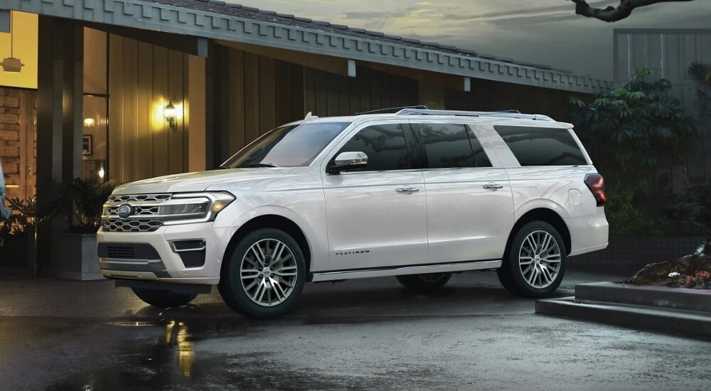 A white 2022 Ford Expedition Platinum is shown on wet pavement.