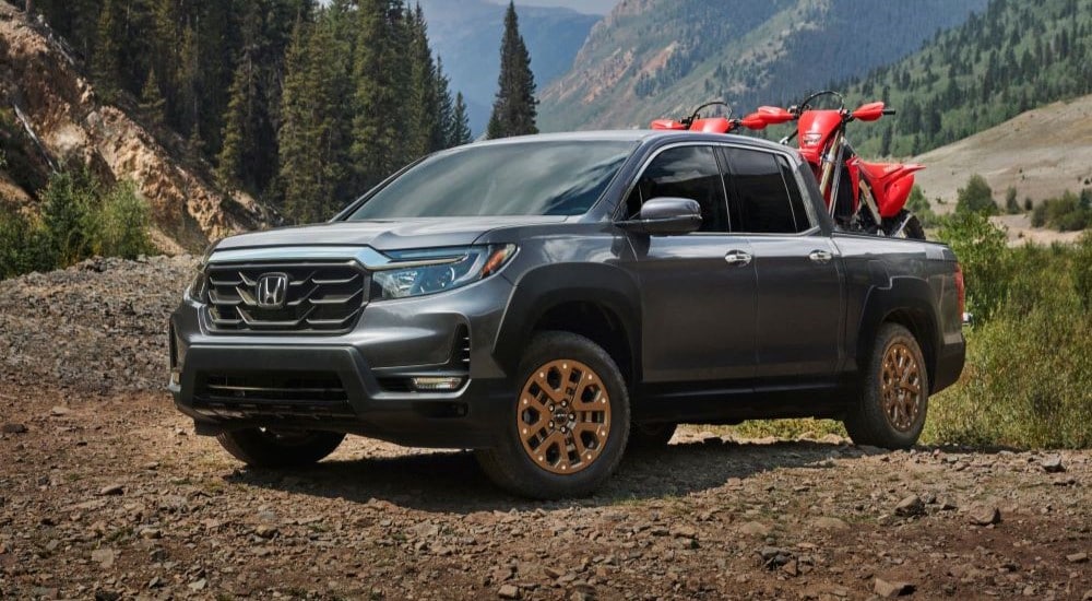 A silver 2021 Honda Ridgeline HPD is shown parked off-road.