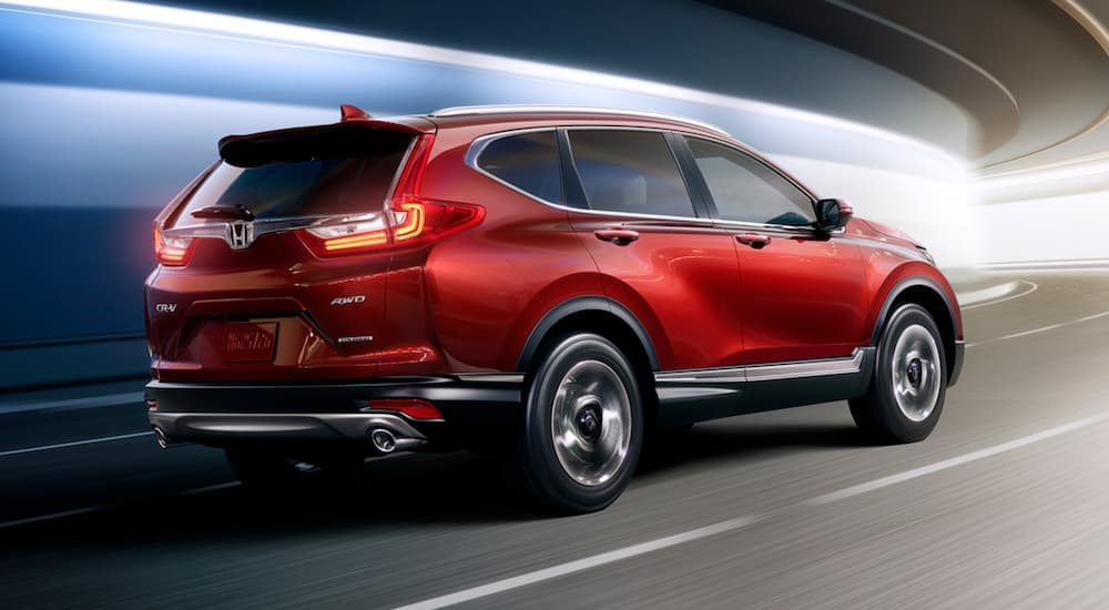 A rear view of a red 2017 Honda CR-V driving through a tunnel.