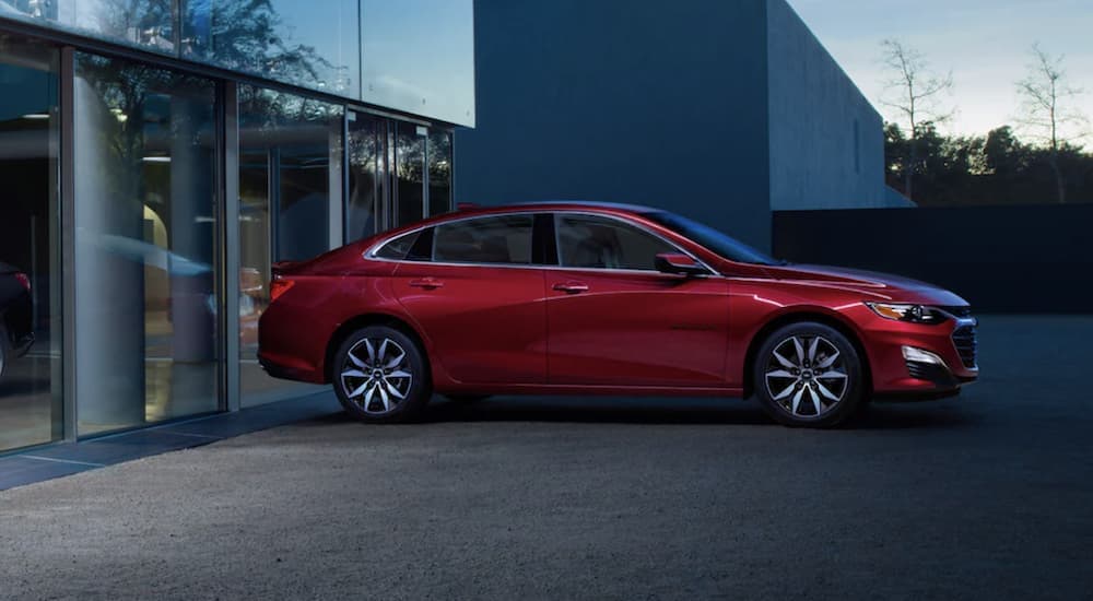A red 2022 Chevy Malibu is shown parked at night.