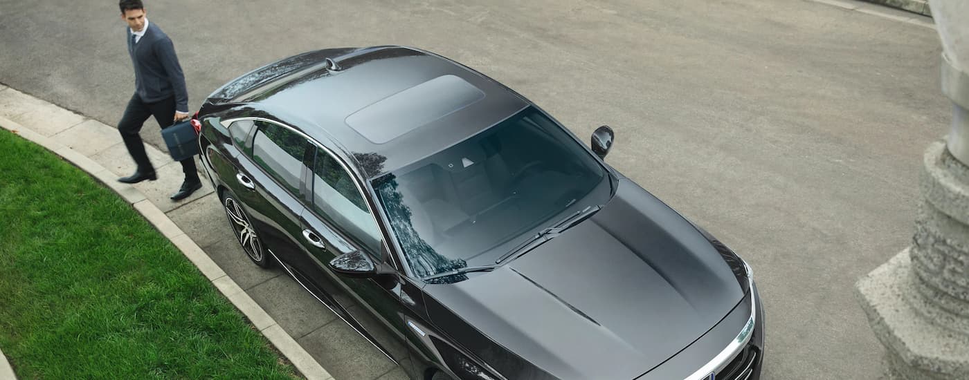 A silver 2022 Honda Accord Hybrid Touring is shown from above parked on the side of a street.