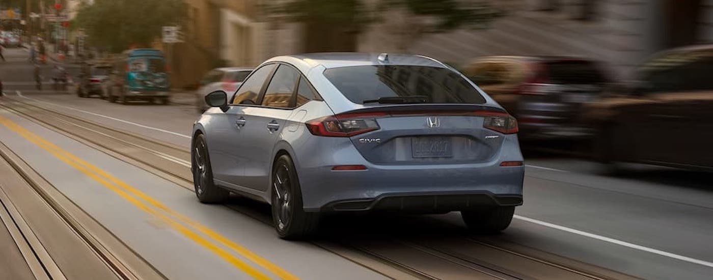 A grey 2022 Honda Civic Hatchback is shown from the rear at an angle.