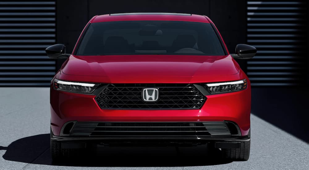A red 2023 Honda Accord Sport Hybrid is shown from the front after Bastrop Honda dealer.