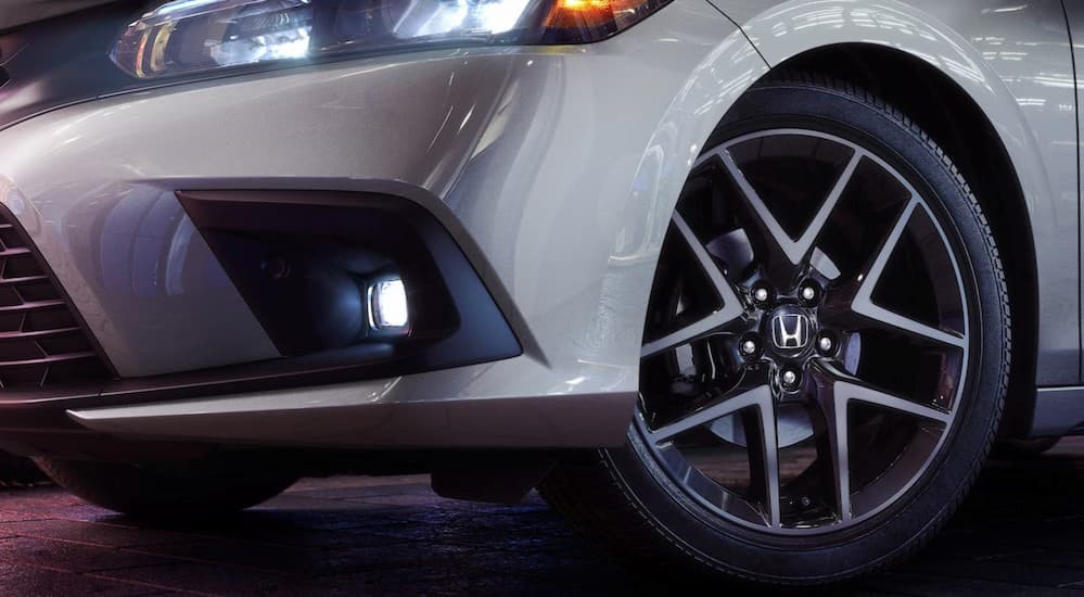 A close-up of a wheel on a silver 2024 Honda Civic is shown.
