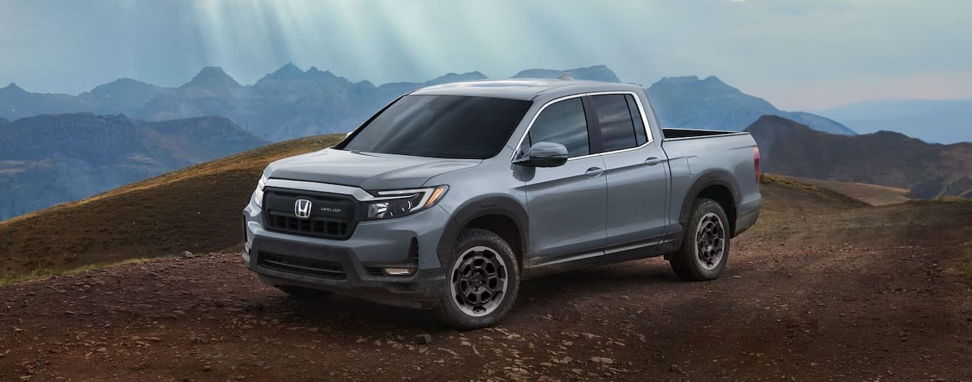 A grey 2024 Honda Ridgeline for sale is shown from the front at an angle.