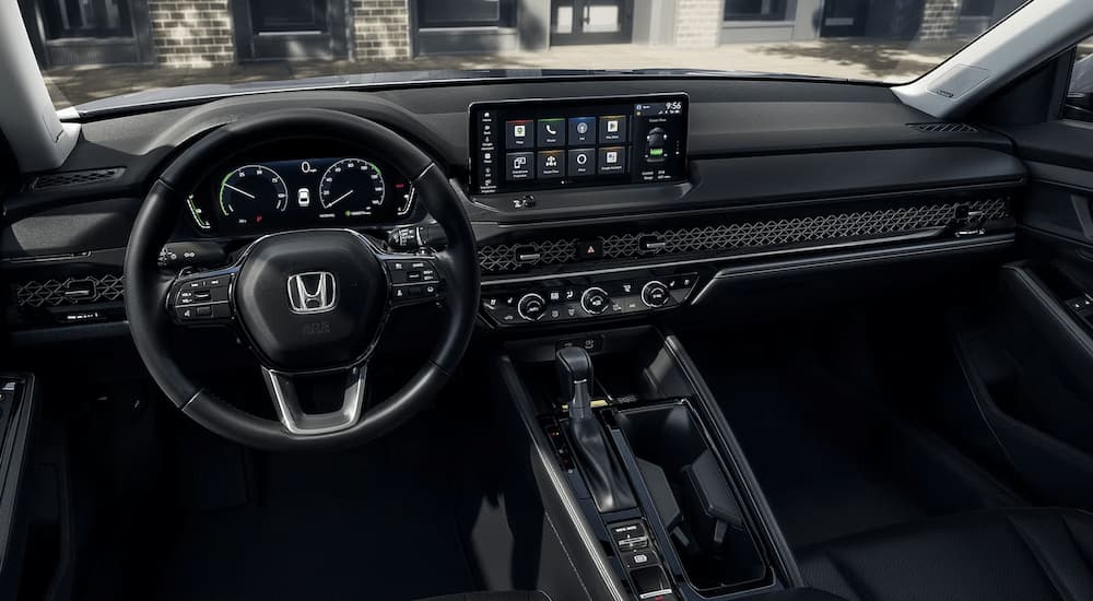 A close up of the center console and dashboard of a 2023 Honda Accord Touring Hybrid is shown.