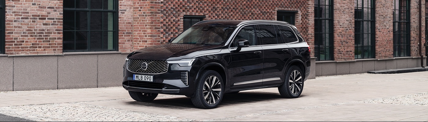 Volvo XC90 Plug-In Hybrid parked outside of a downtown brick building