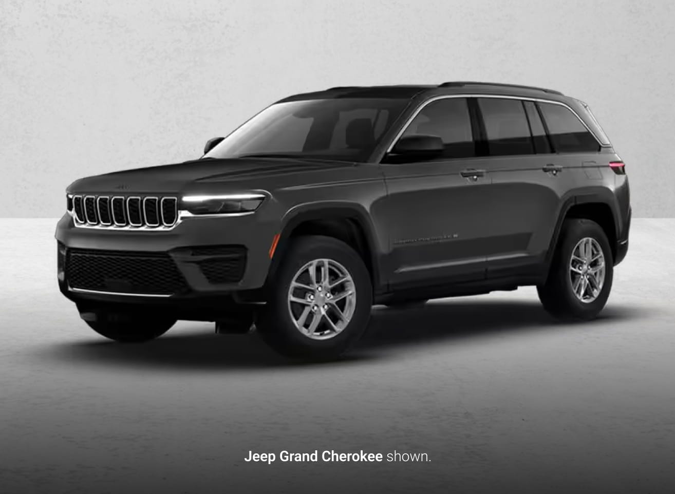 Black Jeep Grand Cherokee shown from a front three-quarter angle.