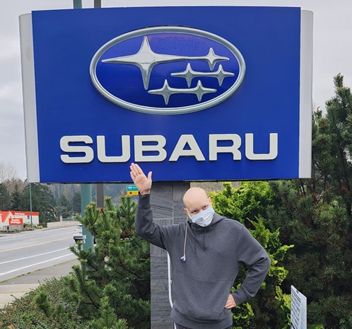  Person cheerfully signing documents.