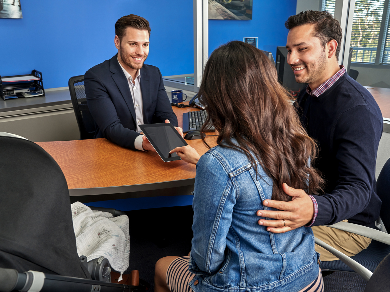 Honda salesperson helping a couple finance their vehicle